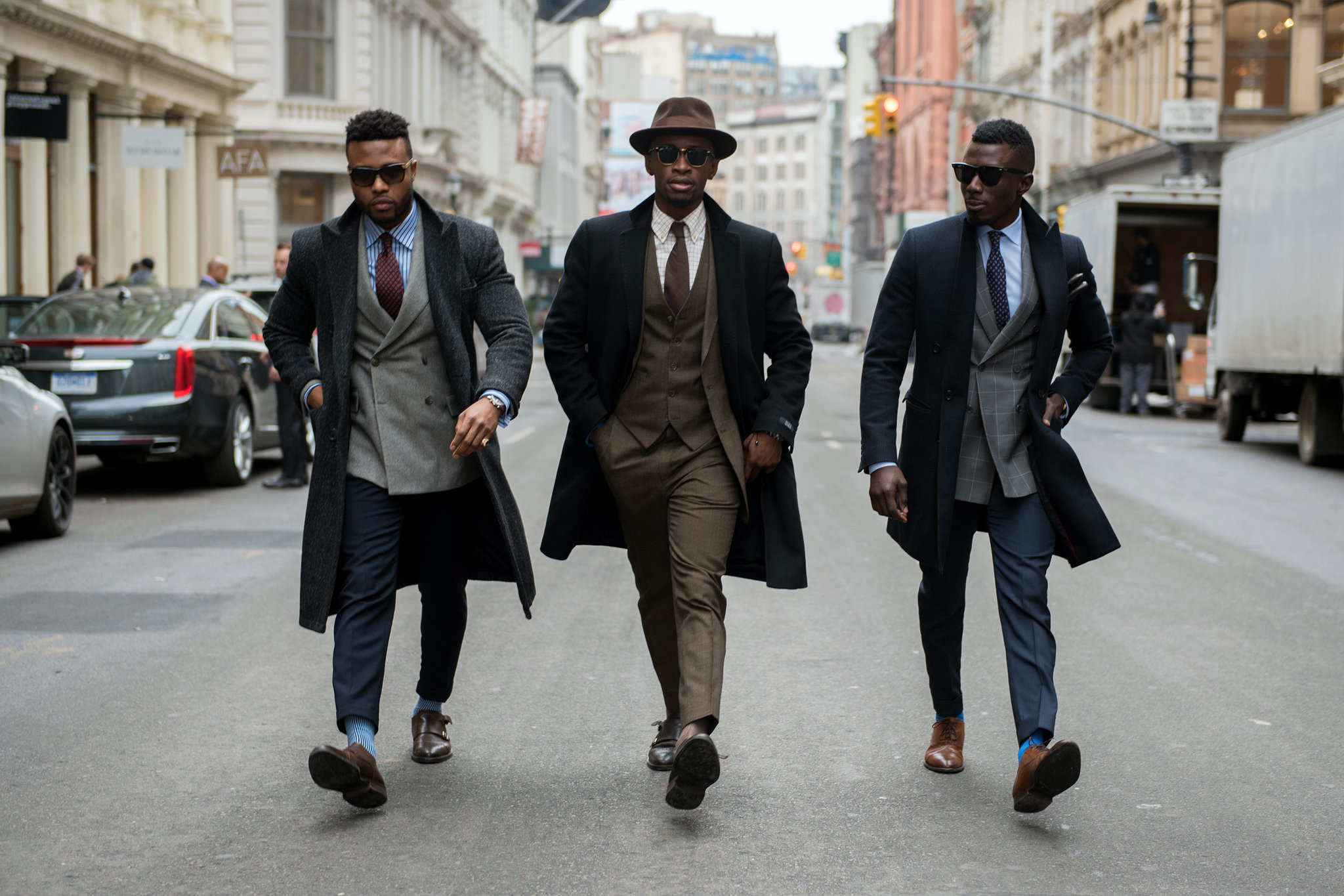 classy black men in suits walking on the street